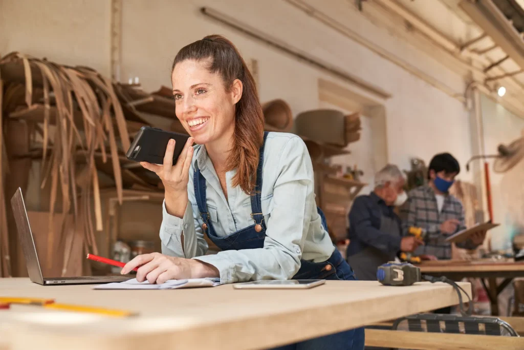 custom cabinet maker talking happily to a client on the phone