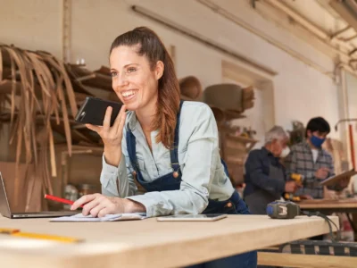 custom cabinet maker talking happily to a client on the phone
